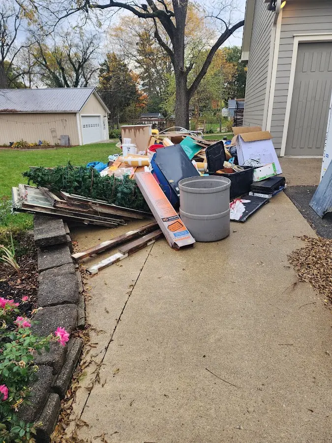 Dumpster being loaded with debris for Roofing Dumpster Rental in McKenzie
